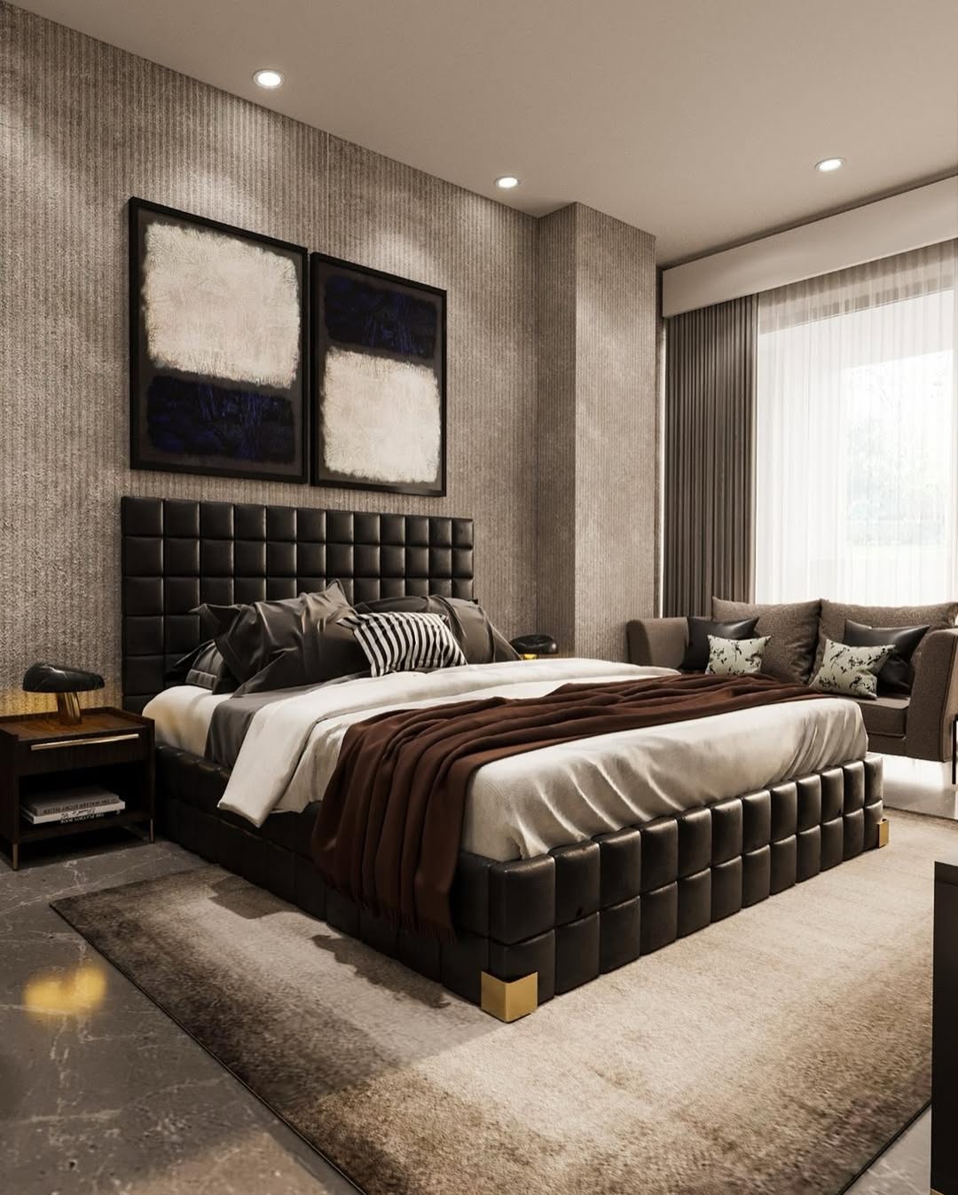 Modern bedroom with a black upholstered bedroom headboard, neutral bedding, two abstract artworks above the headboard, a nightstand, and a window with sheer curtains.