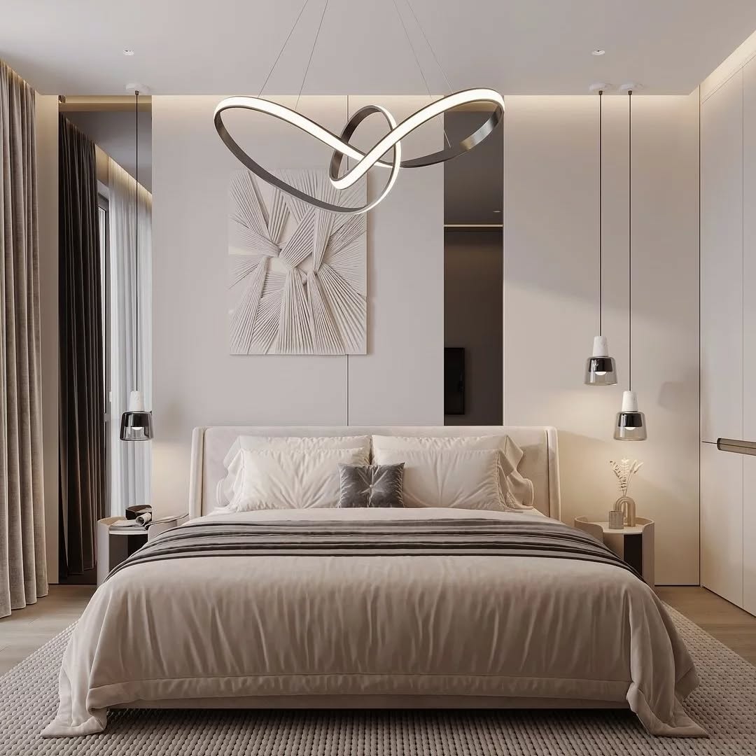 A modern bedroom with a large bed featuring a sleek bedroom headboard, neutral bedding, abstract wall art, pendant lights, and a sculptural ceiling light fixture.