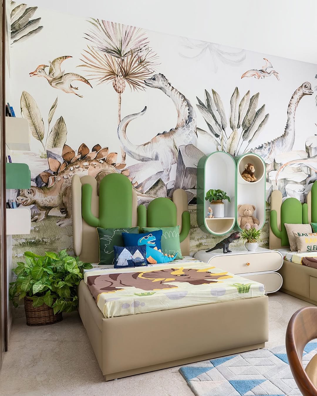A vibrant dinosaur bedroom, perfect for kids, showcases a dinosaur-themed decor with a bed adorned in green cushions. Dinosaur toys dot the room and a mural of prehistoric plants and dinosaurs brings the walls to life.