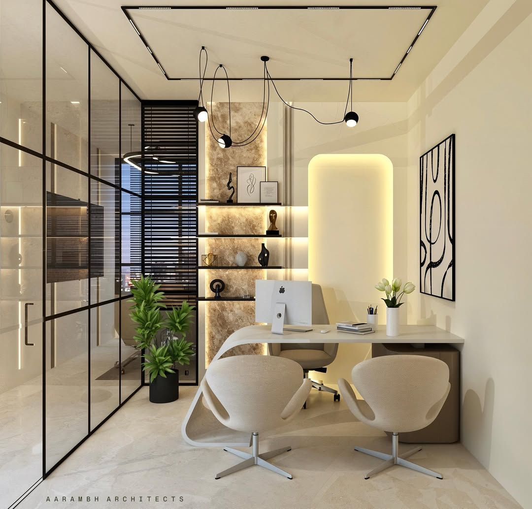 Modern office with glass walls, two beige chairs at a desk with a computer, shelves with decor, potted plants, and abstract wall art. Ceiling lights and neutral tones highlight minimalist office design and inspire new office design ideas.