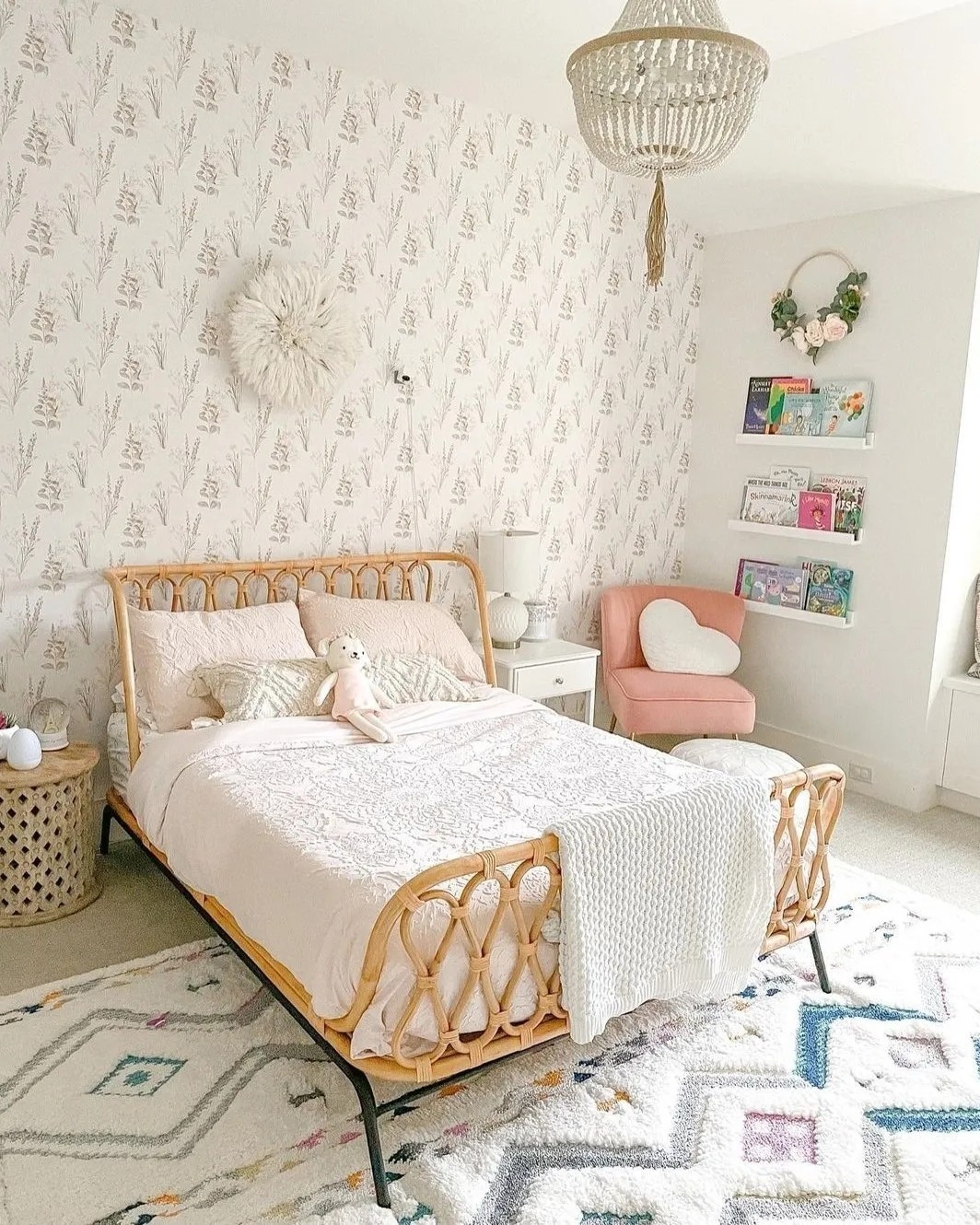 A coastal-themed teen girl bedroom with blue walls, a twin bed with striped bedding, nautical decor, a wicker pendant light, and a striped rug and bench. Natural light streams in through shutters for a fresh, airy vibe.