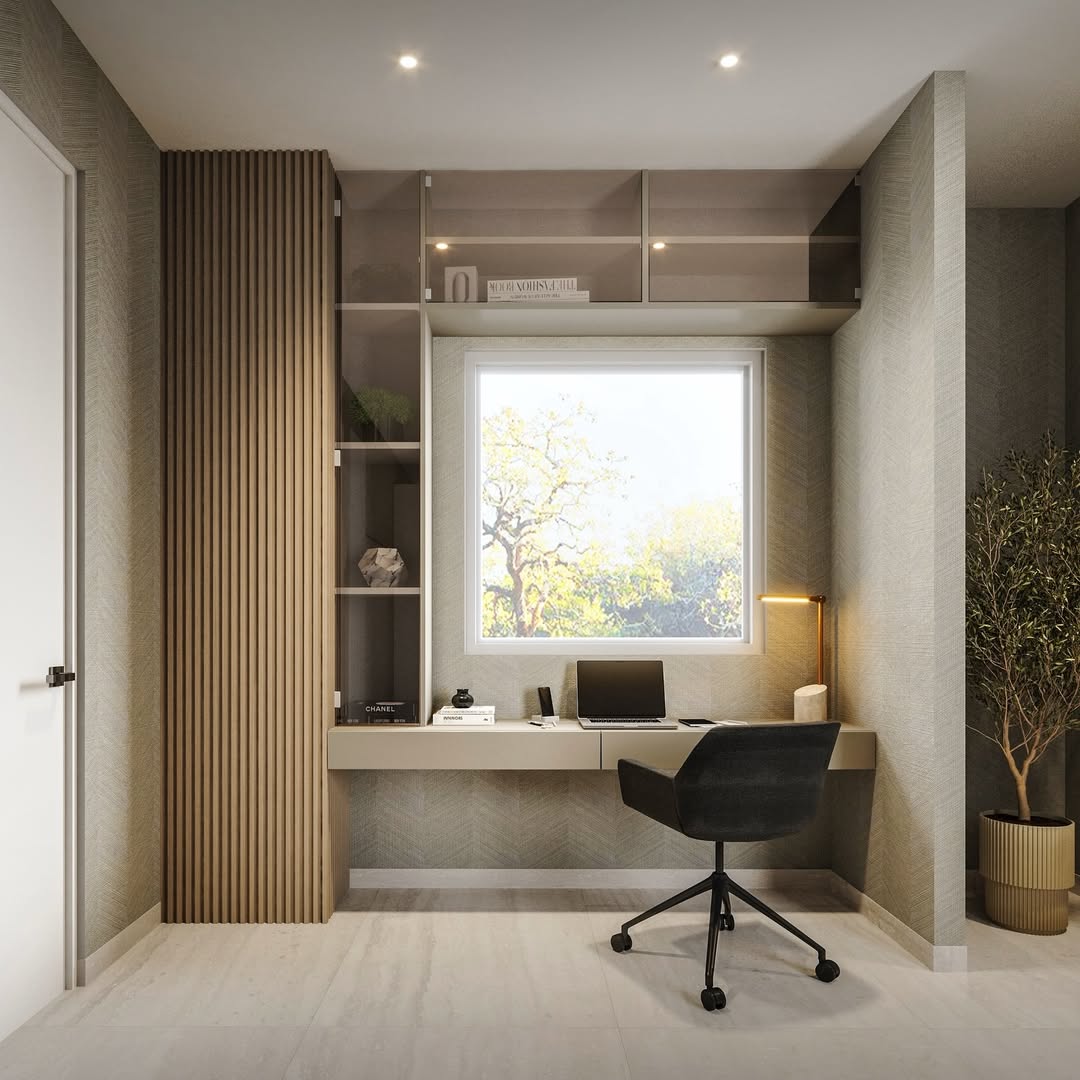 Minimalist office design with a floating desk, laptop, lamp, black swivel chair, open shelves, and a window showing trees outside. Neutral tones and a potted plant complete this inspiring space for modern office design ideas.