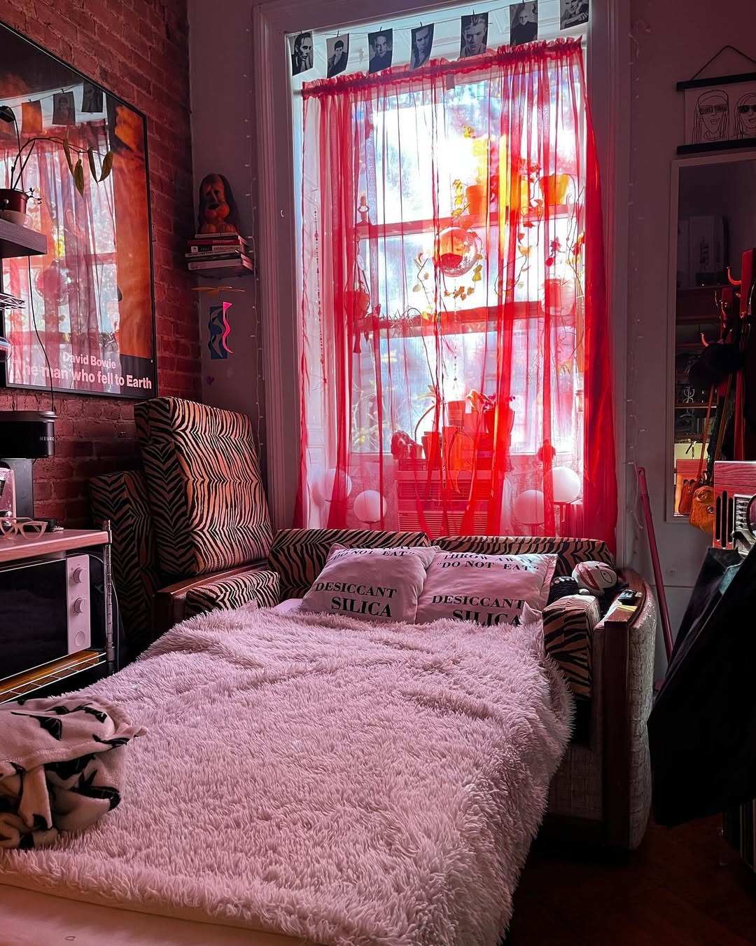 This funky retro bedroom features a bed draped in a fluffy white blanket, with pillows labeled