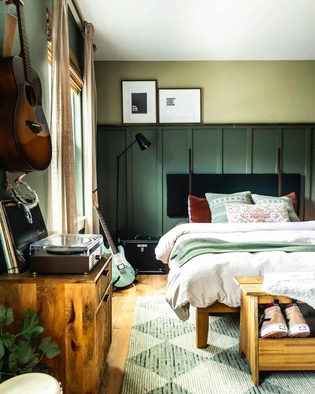 A cozy teen boy bedroom featuring a double bed, wooden furniture, two guitars, framed art on the wall, a record player, and a patterned rug.
