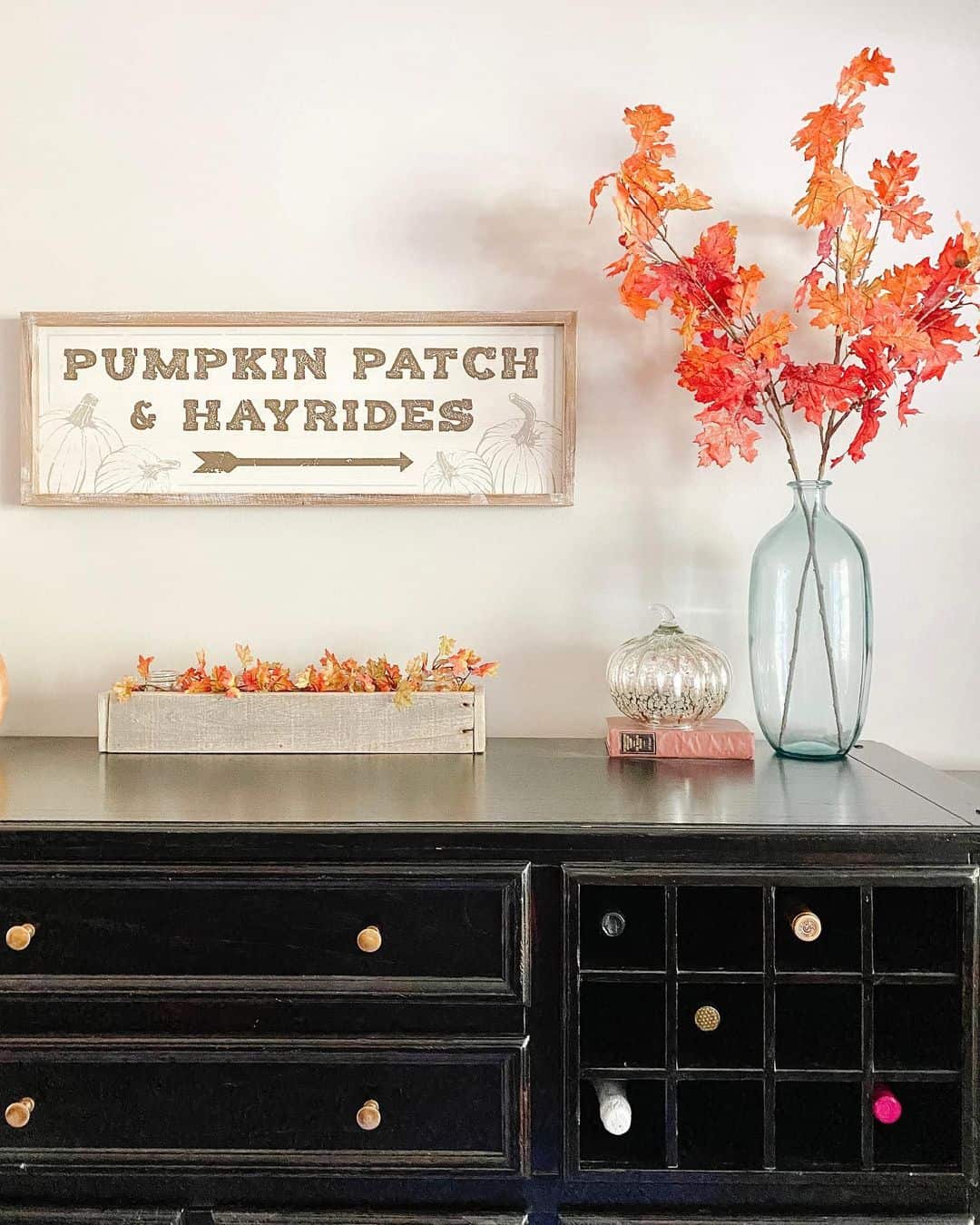 Tall Glass Vase Holds Fiery Autumn Branches for a Dramatic Statement