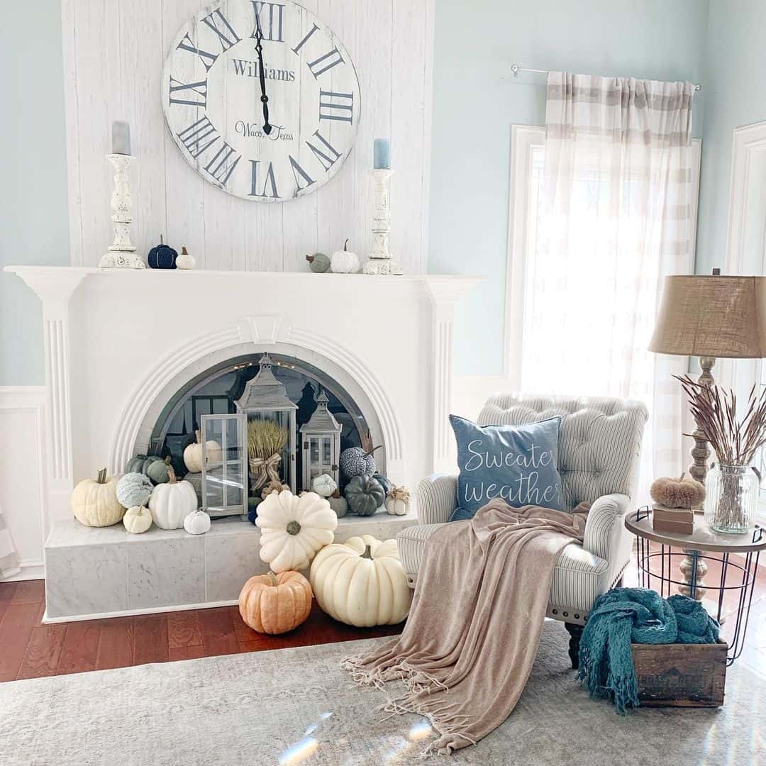 White Pumpkins and Lanterns Fill Fireplace Hearth