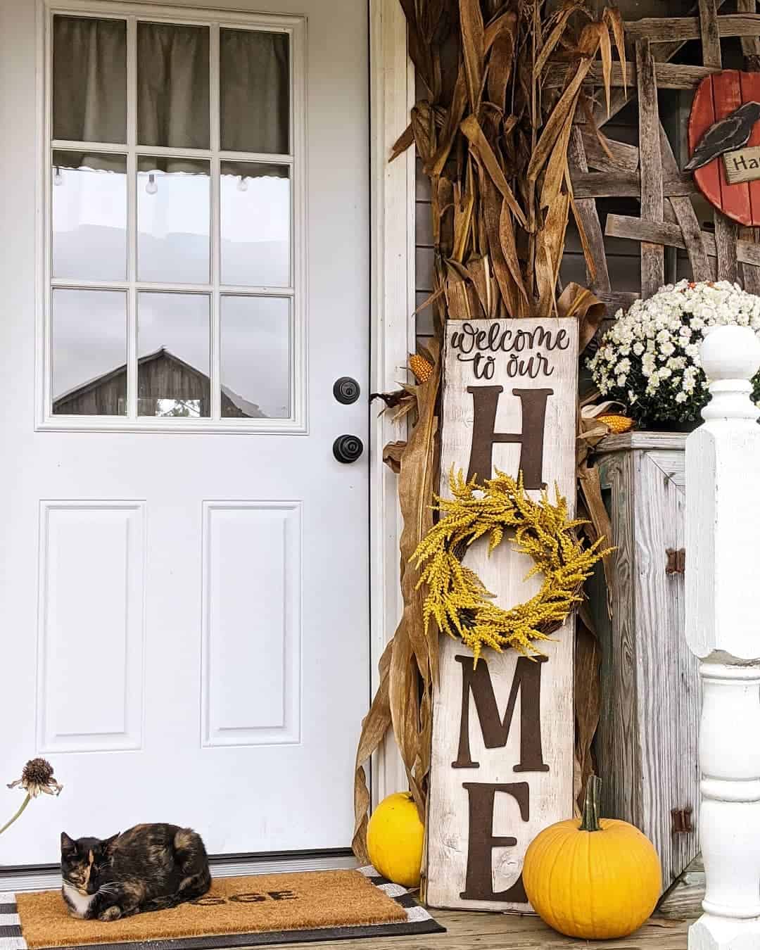 Weathered 'HOME' Sign with Yellow Wreath and Corn Stalks