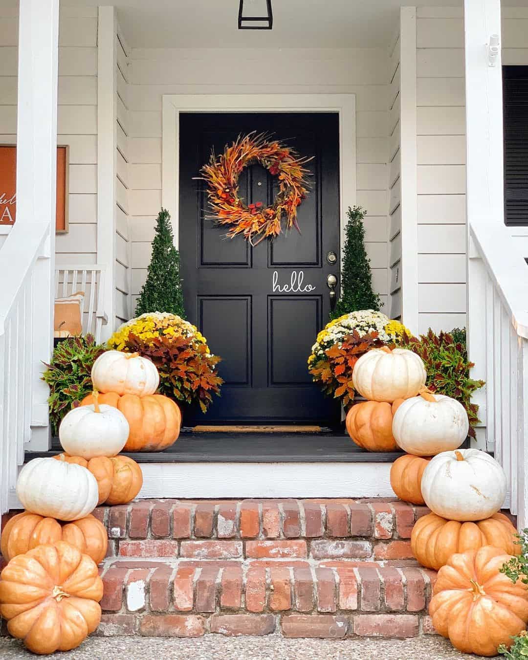 White Pumpkins Contrast with Orange Gourds on Brick Steps