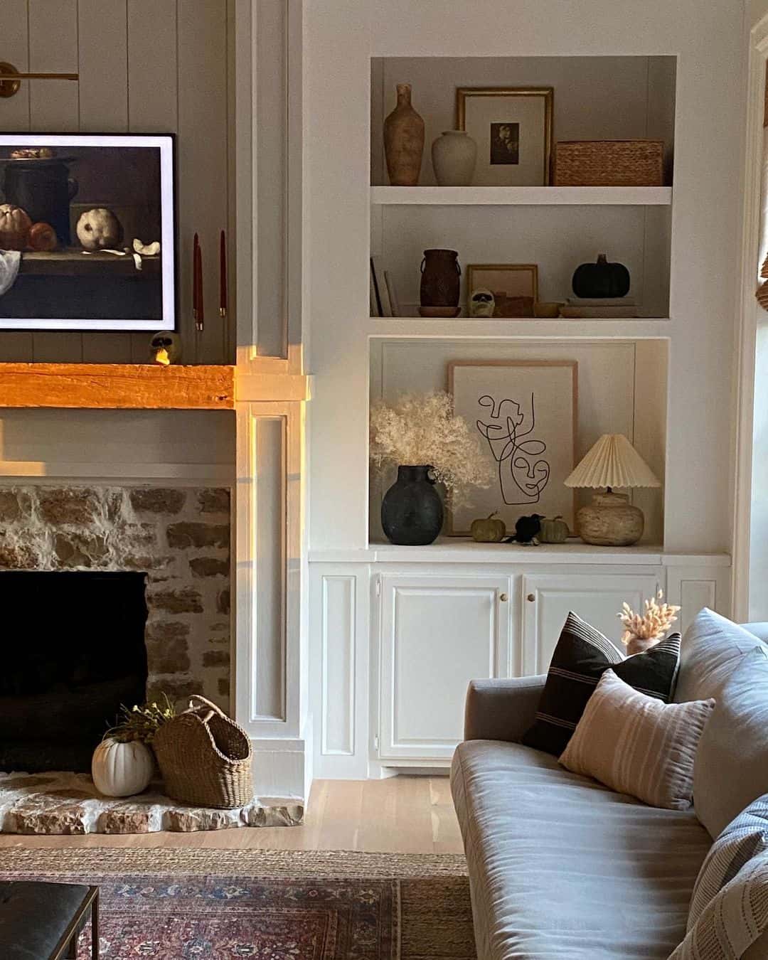 Muted Black Pumpkins Anchor a Chic Bookshelf Display
