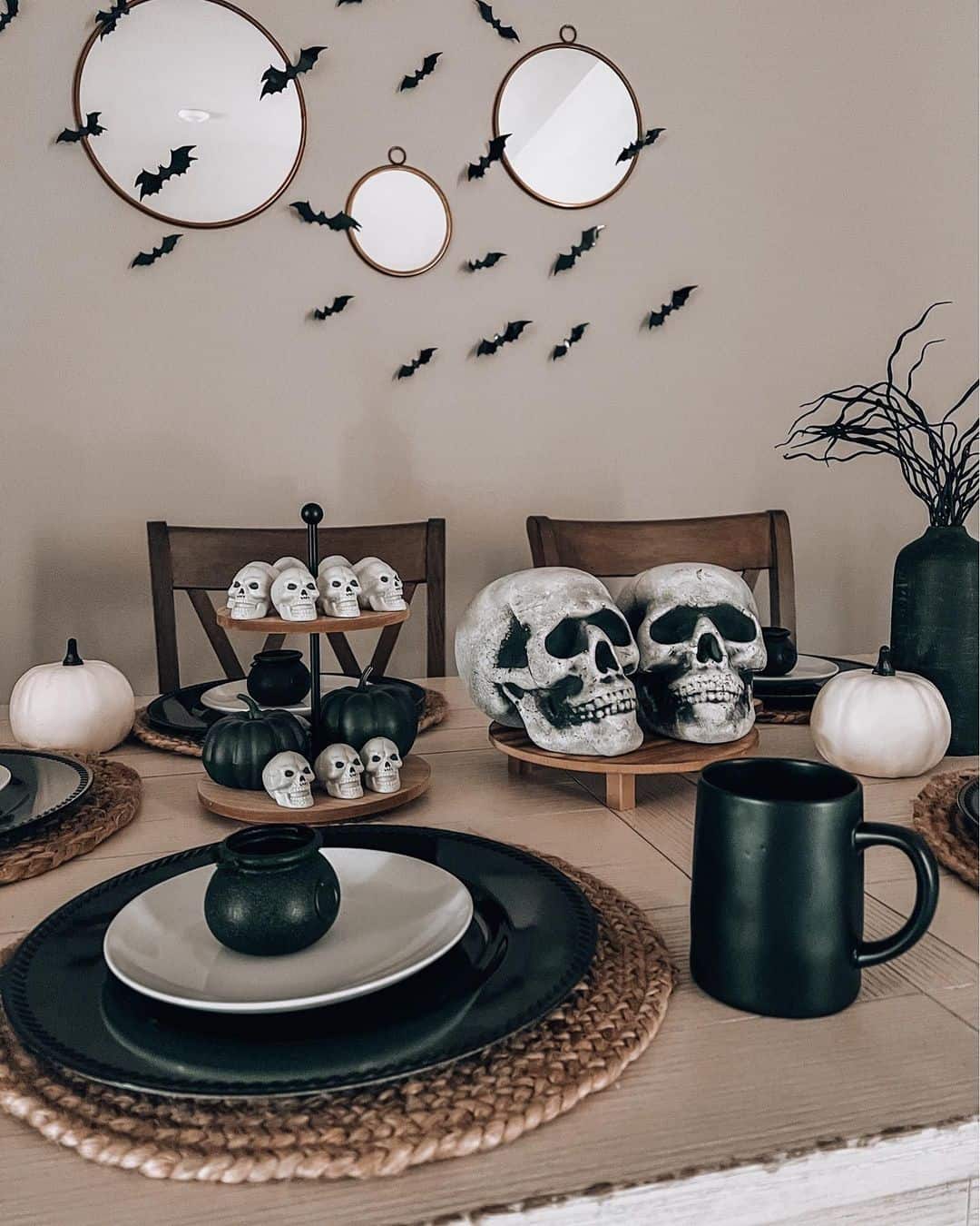 Tiered Stand Displays Black Pumpkins and Mini Skulls