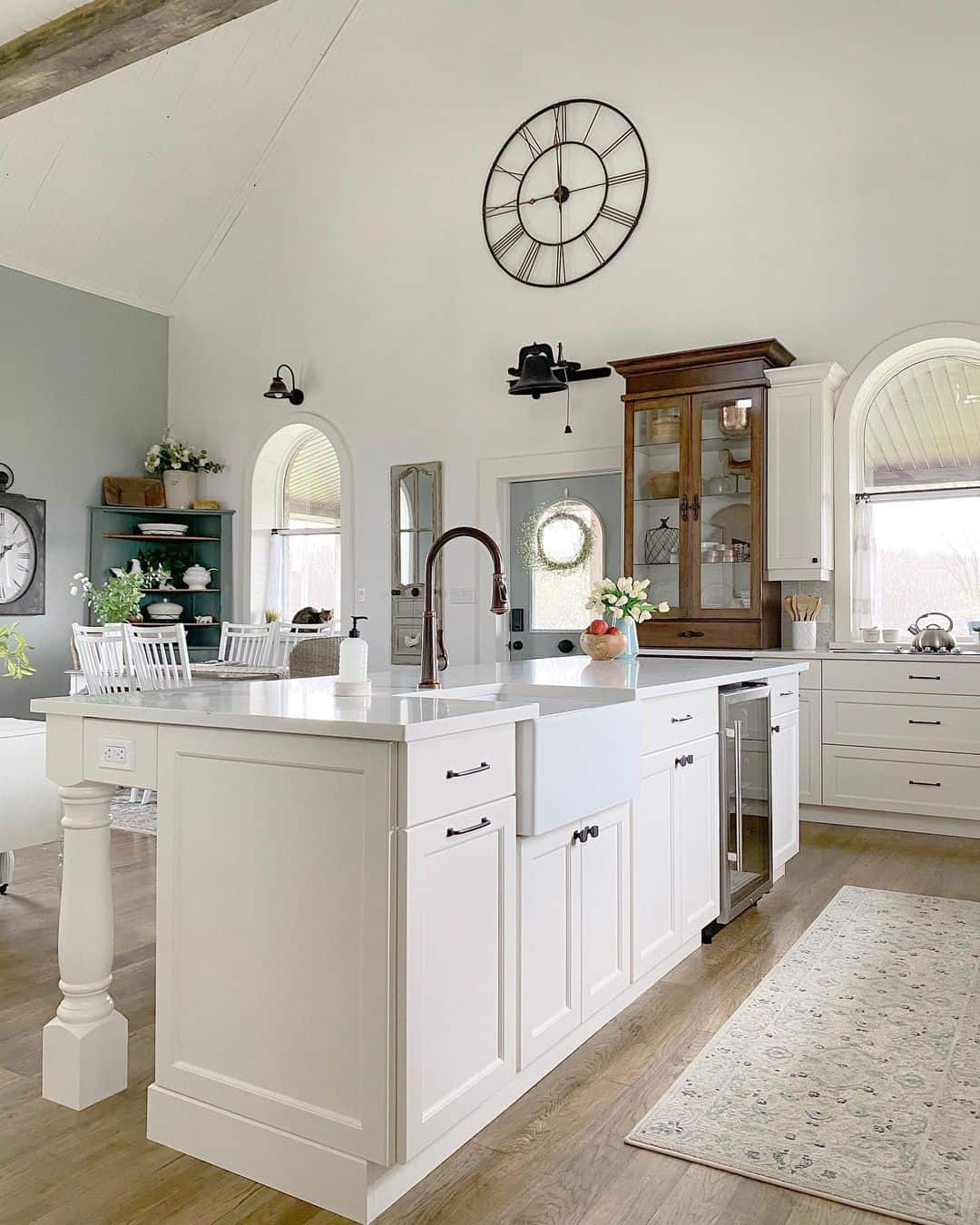 Oversized Black Metal Clock Anchors a Vaulted Ceiling