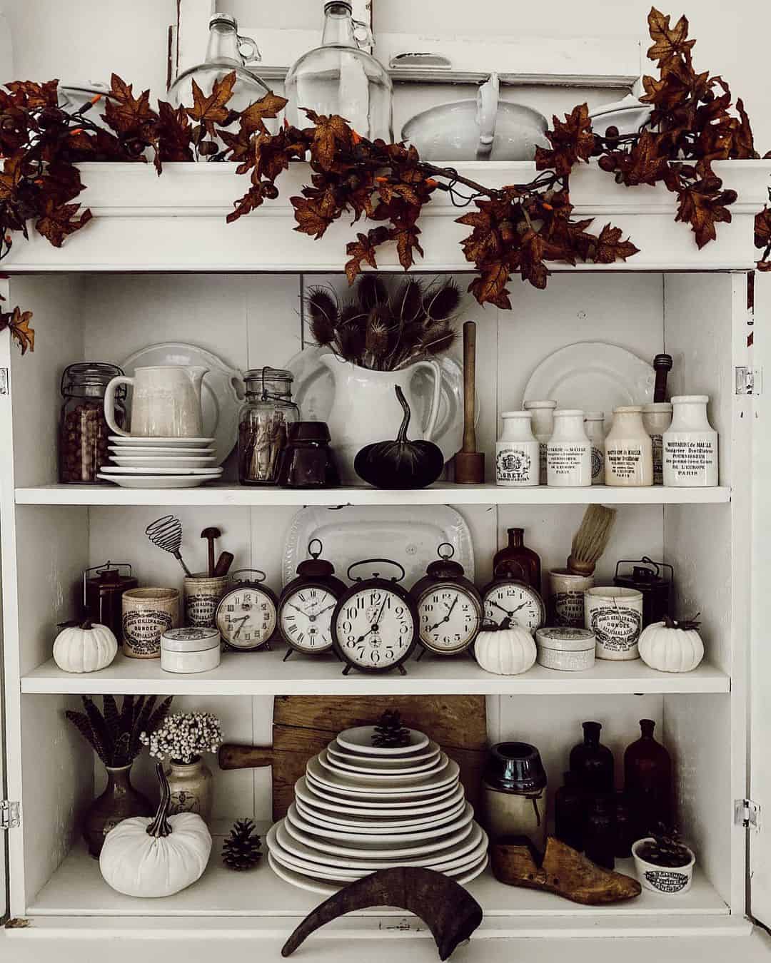 Faux Fall Leaf Garland Frames a Cabinet Display