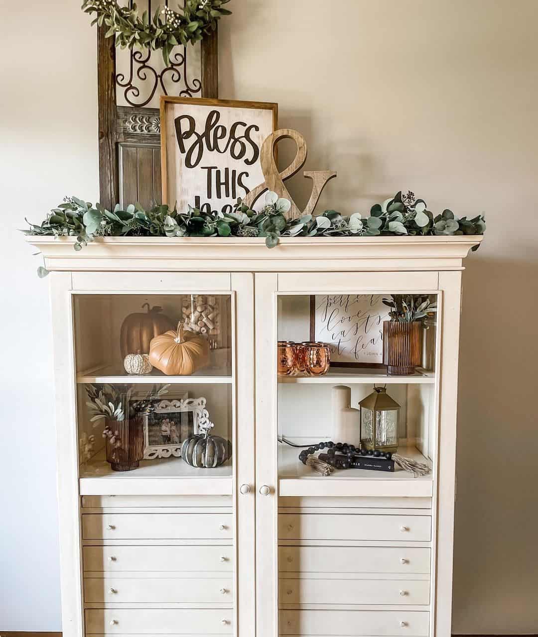 Greenery Garland Frames a Shelf Display of Fall Decor