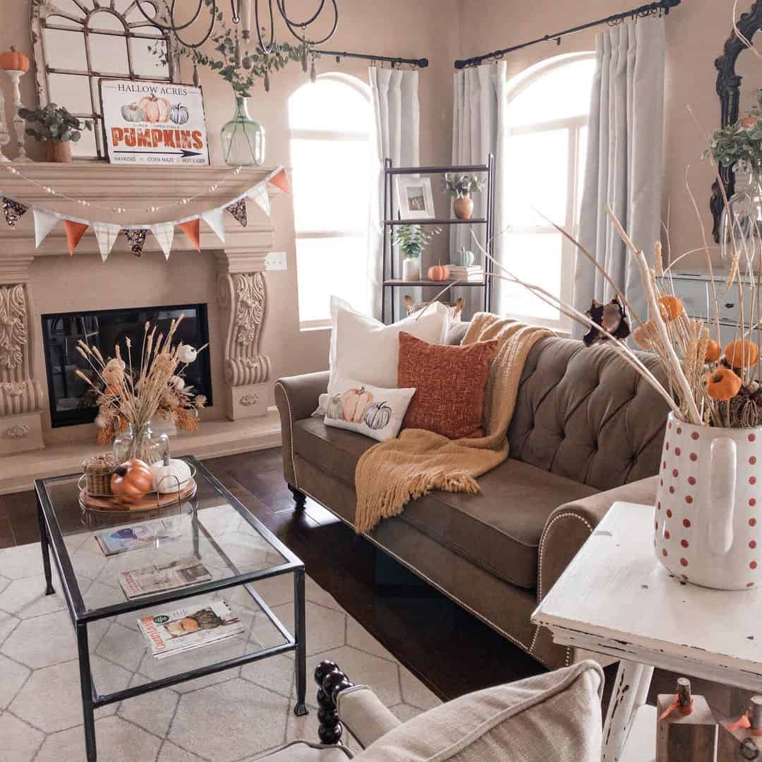 Orange and white polka dot vase holds dried grasses and mini pumpkins