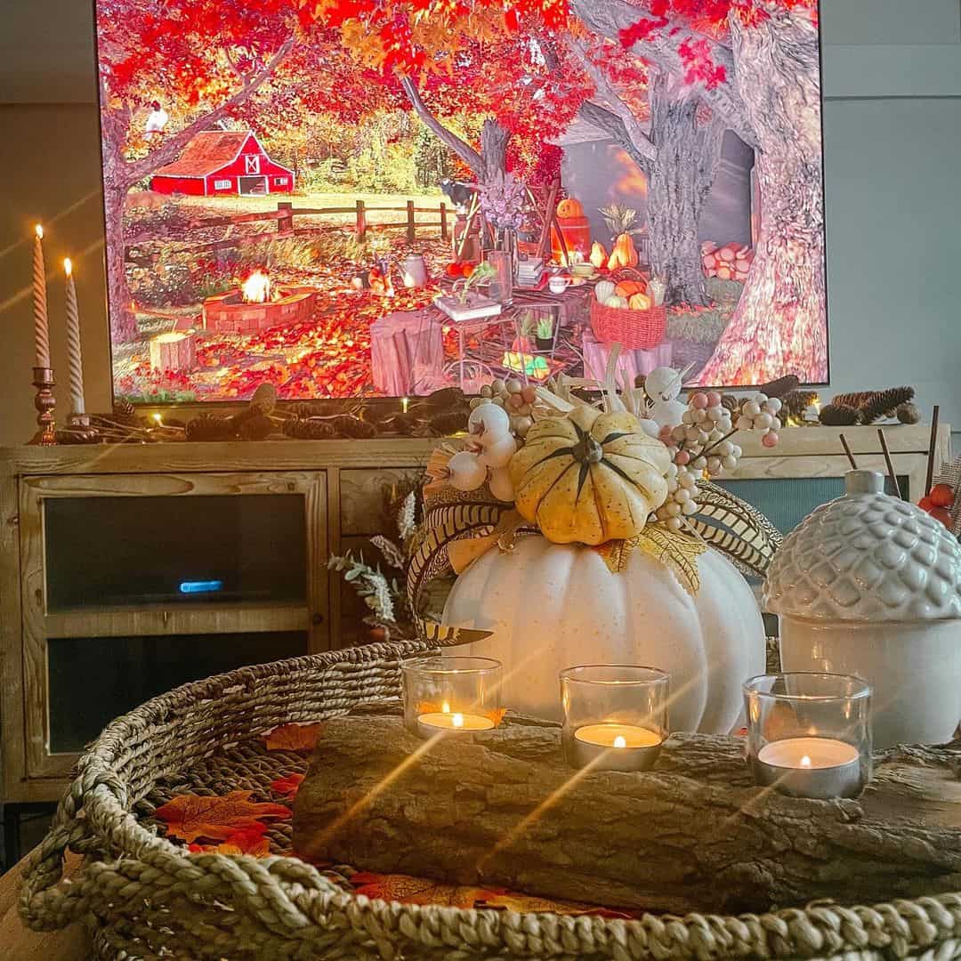 Layered pumpkins and candles create a cozy centerpiece