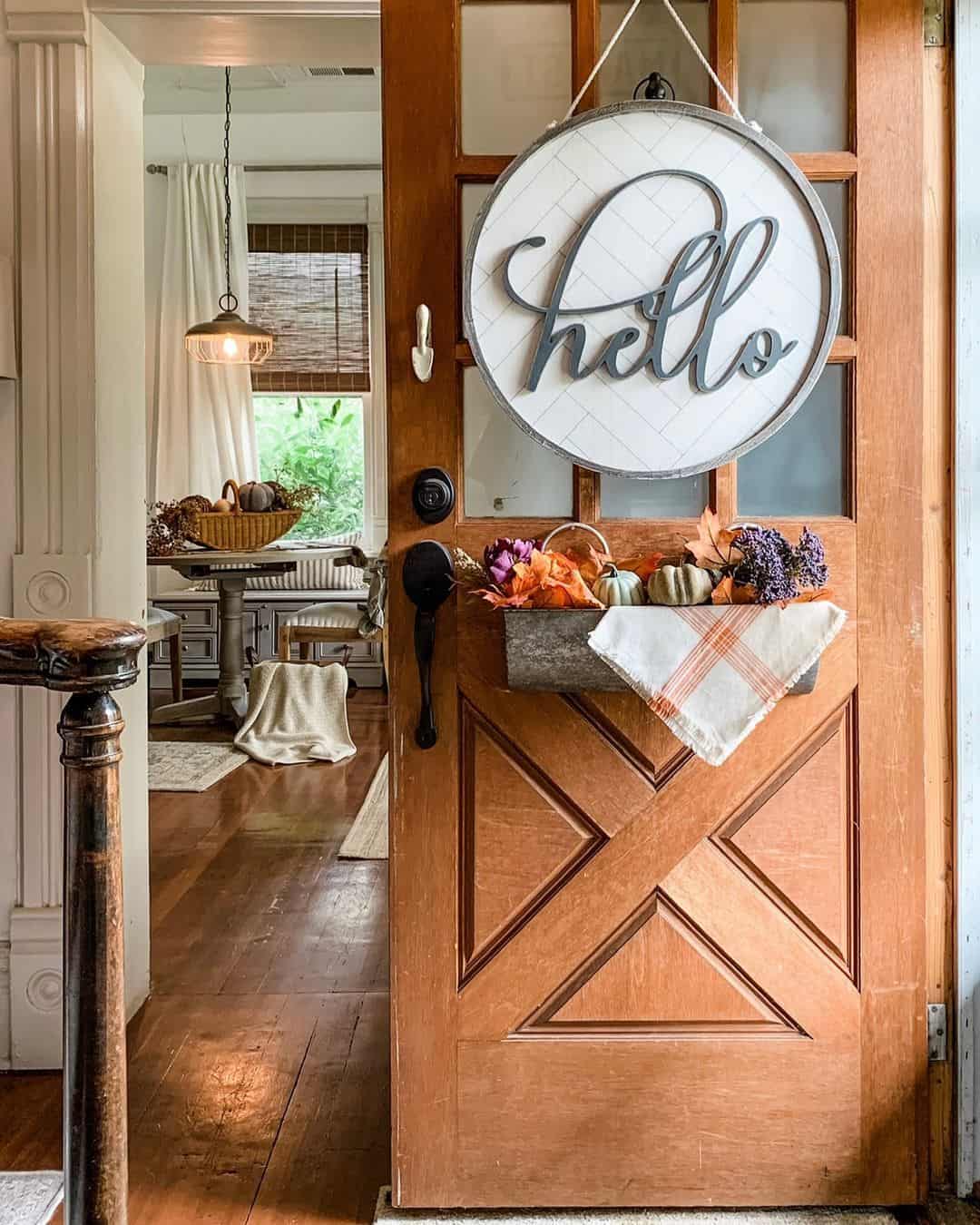 Galvanized Box Holds Autumn Accents Below a Round Sign