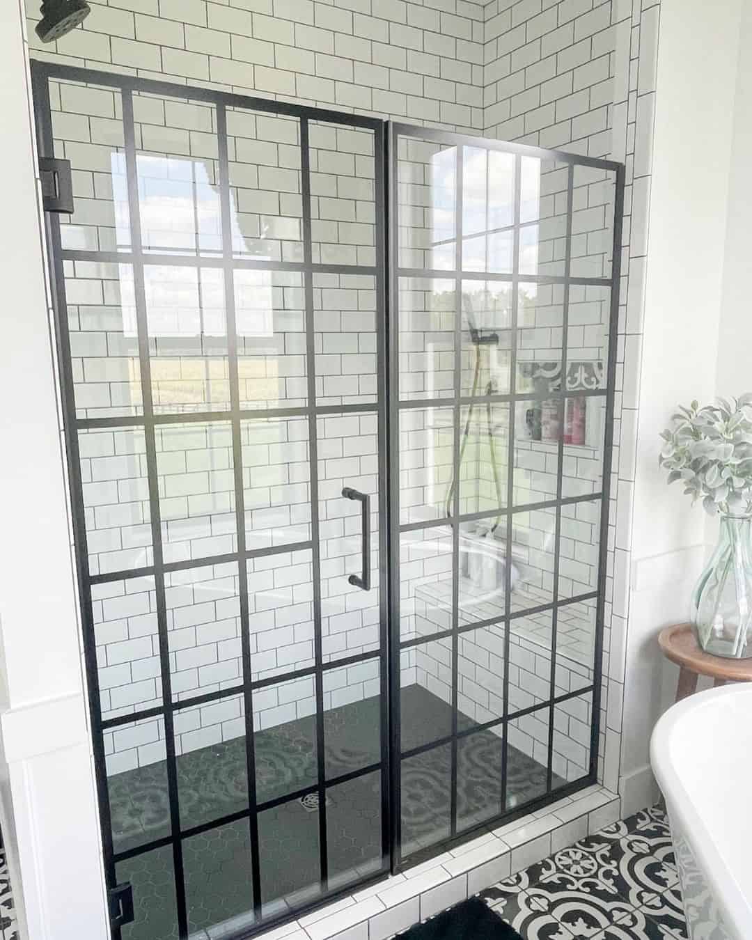 Well Lit Bathroom with Black Shower Door