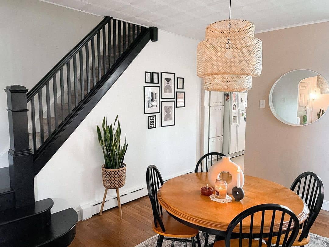 Pedestal Table Beside a Black Staircase