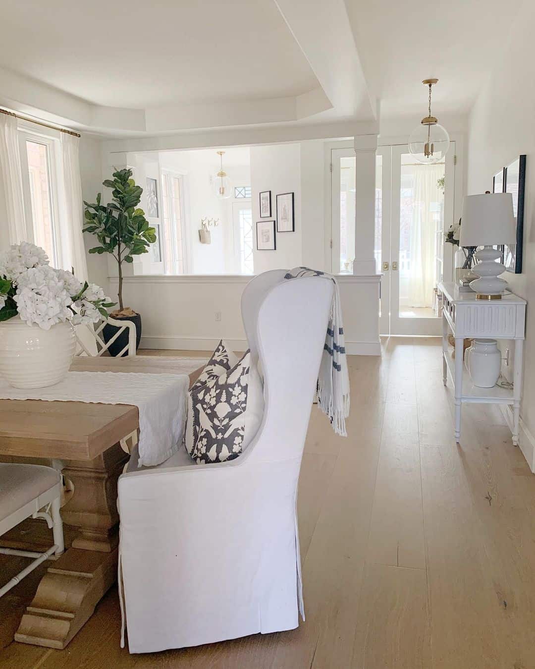 White Farmhouse Dining Room With Upholstered Chairs