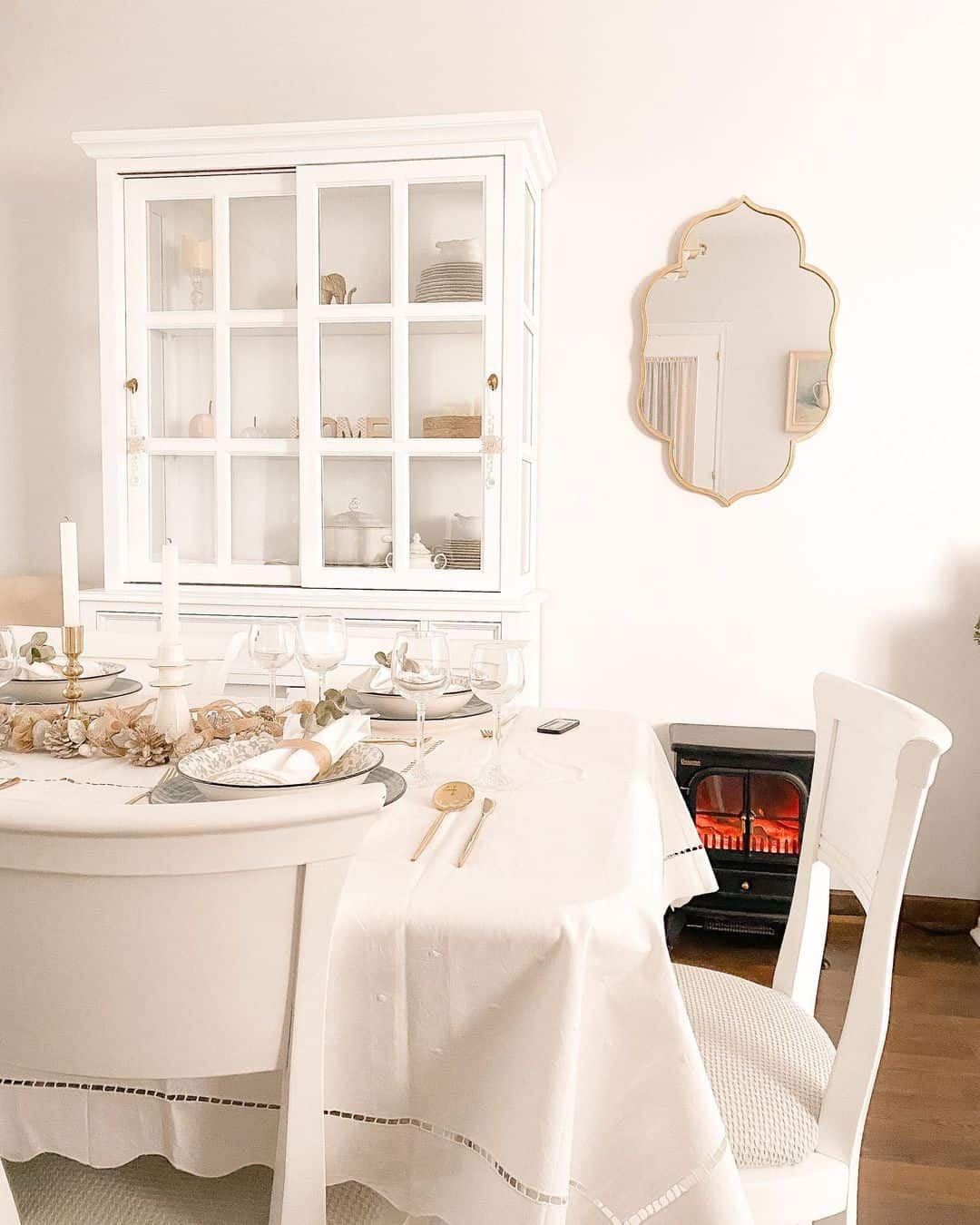White Farmhouse Dining Room With Gold Accents