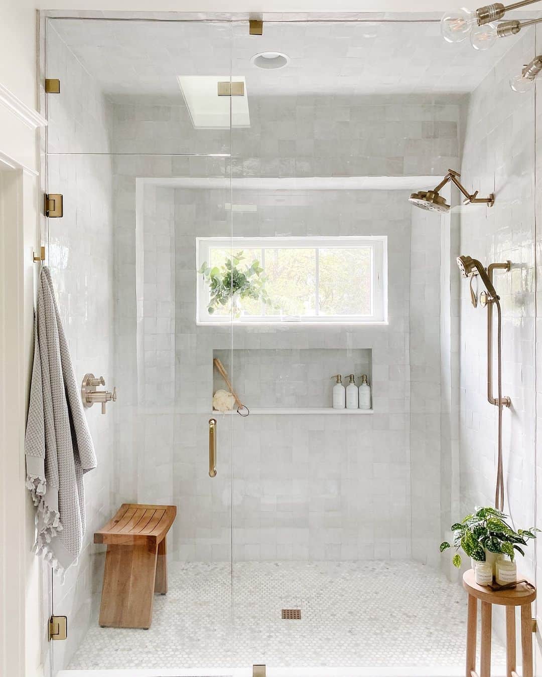 Brass Shower Heads and White Bottles on a Niche Shelf