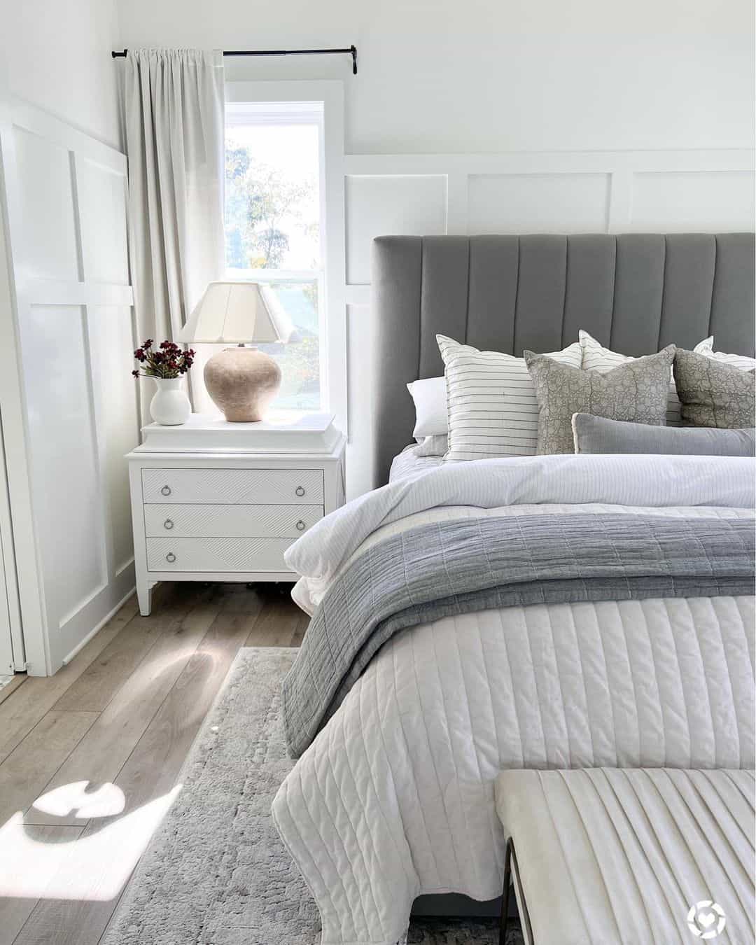 Large Gold Lamp on a White Nightstand