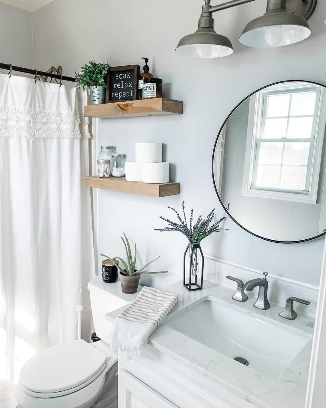 White Bathroom with Circular Black Mirror