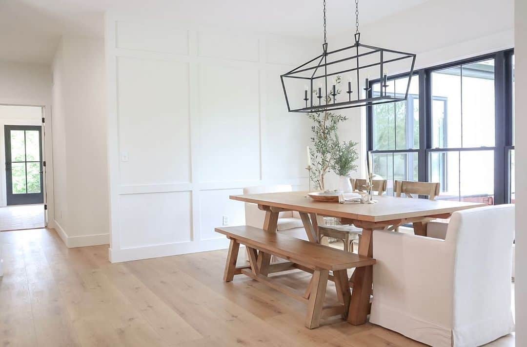 Large Armchairs and a Light Wood Bench at a Dining Room Table