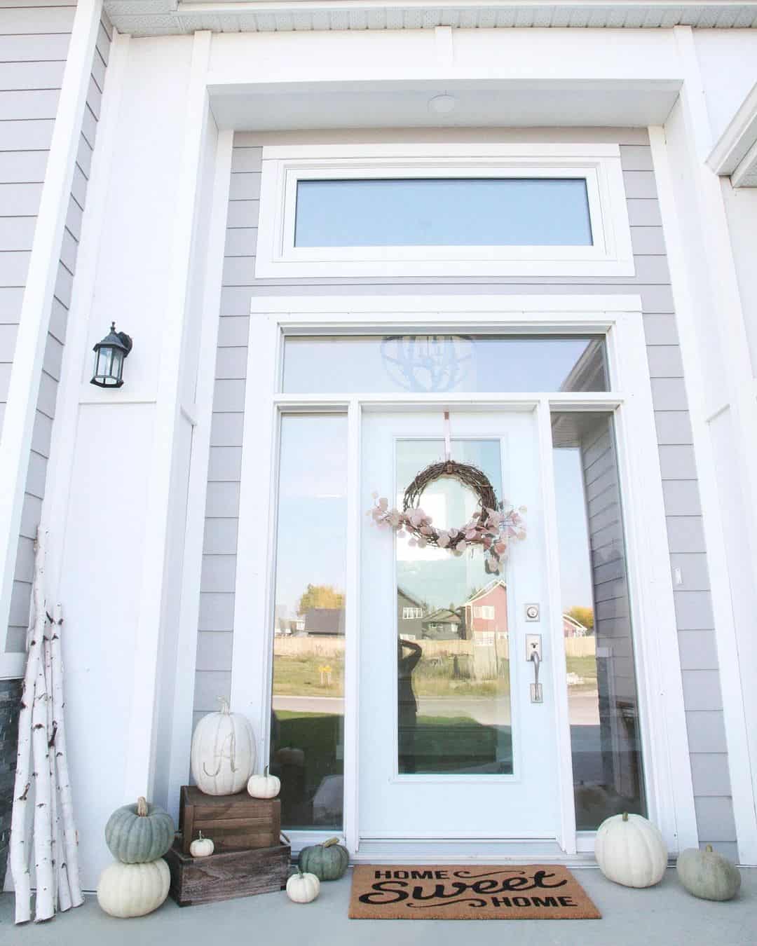 Pink Flowers on a White Front Door with Sidelights and a Transom
