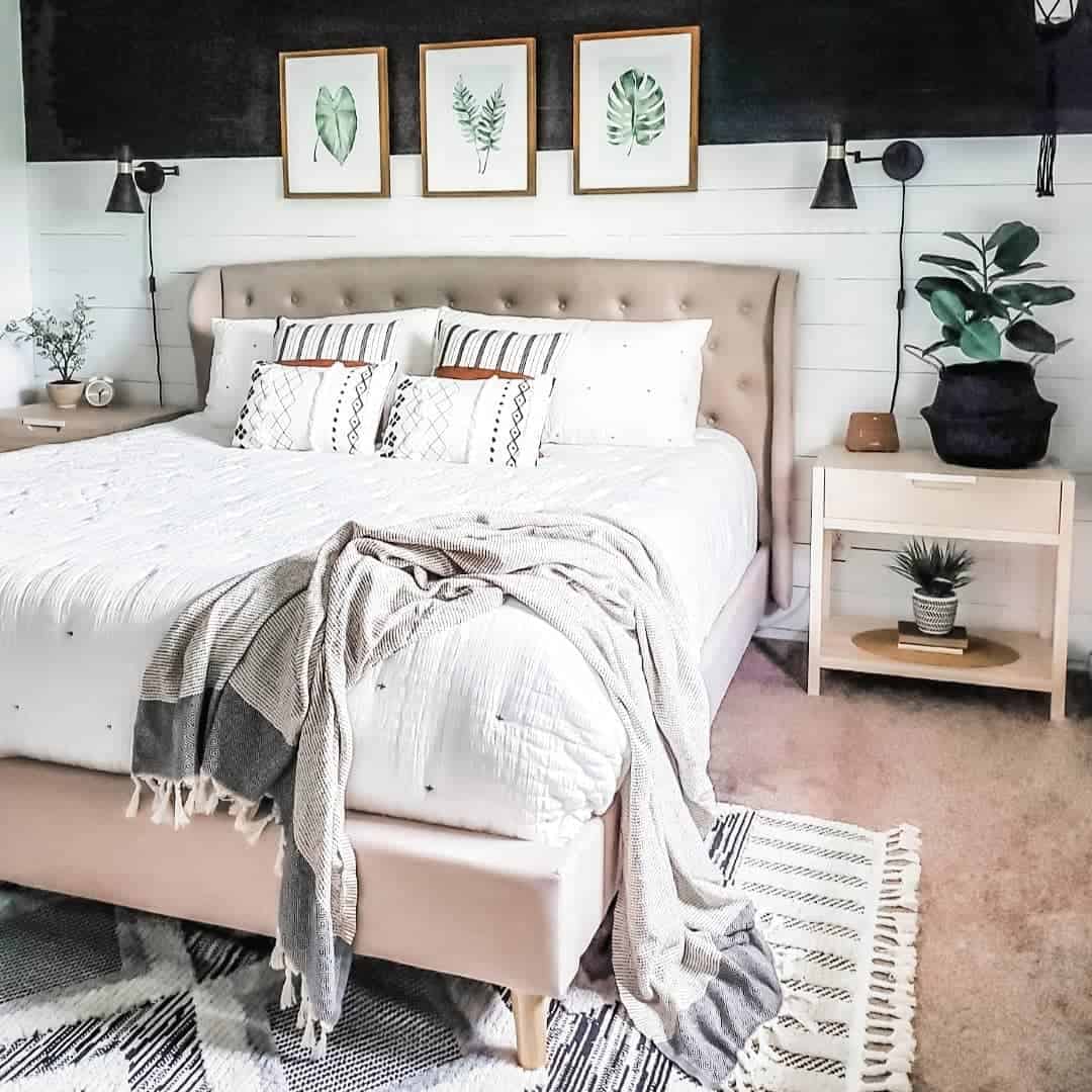 Bed Against a Shiplap Wall With Reading Lights