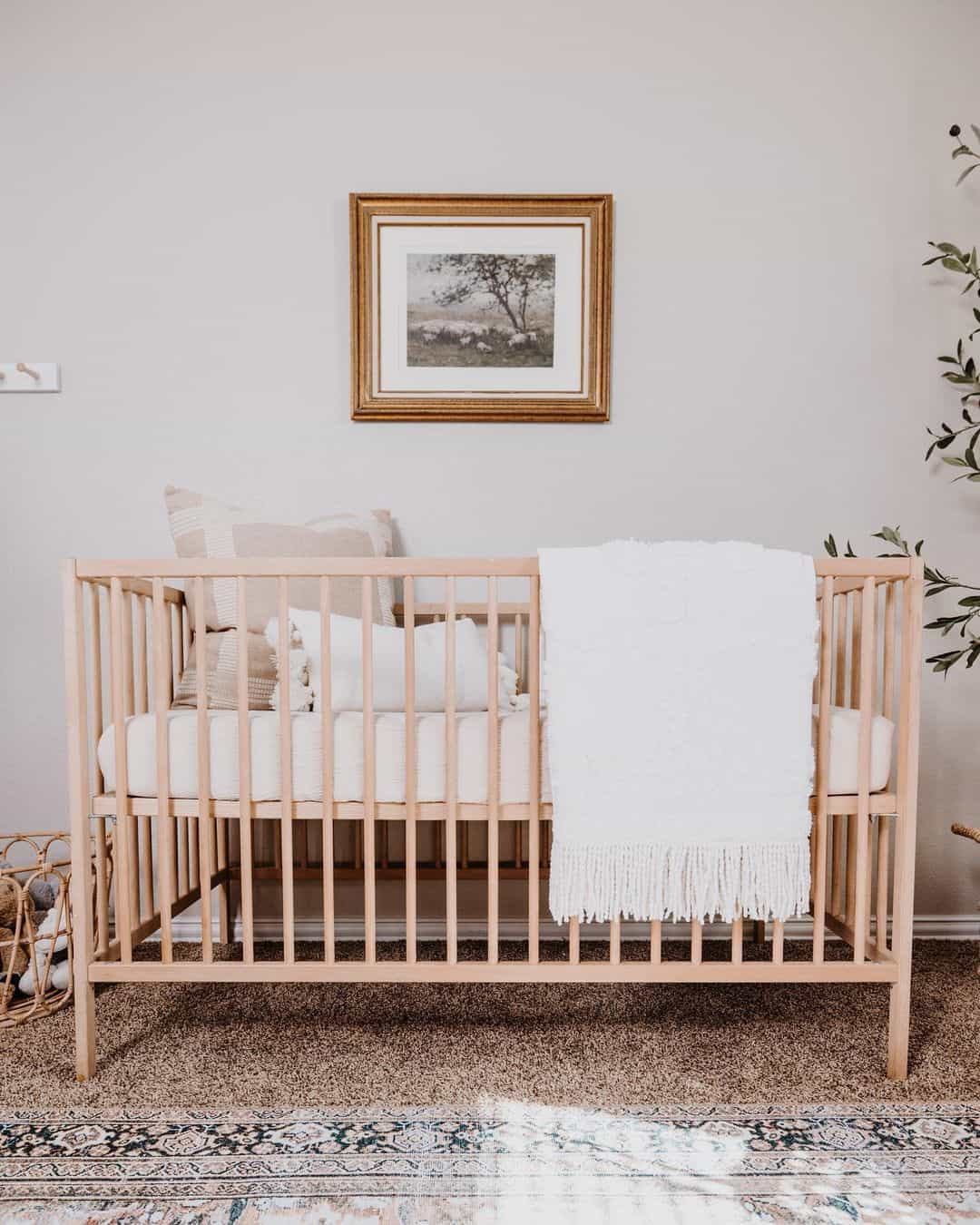 Calm Neutral Crib Corner with Landscape Print