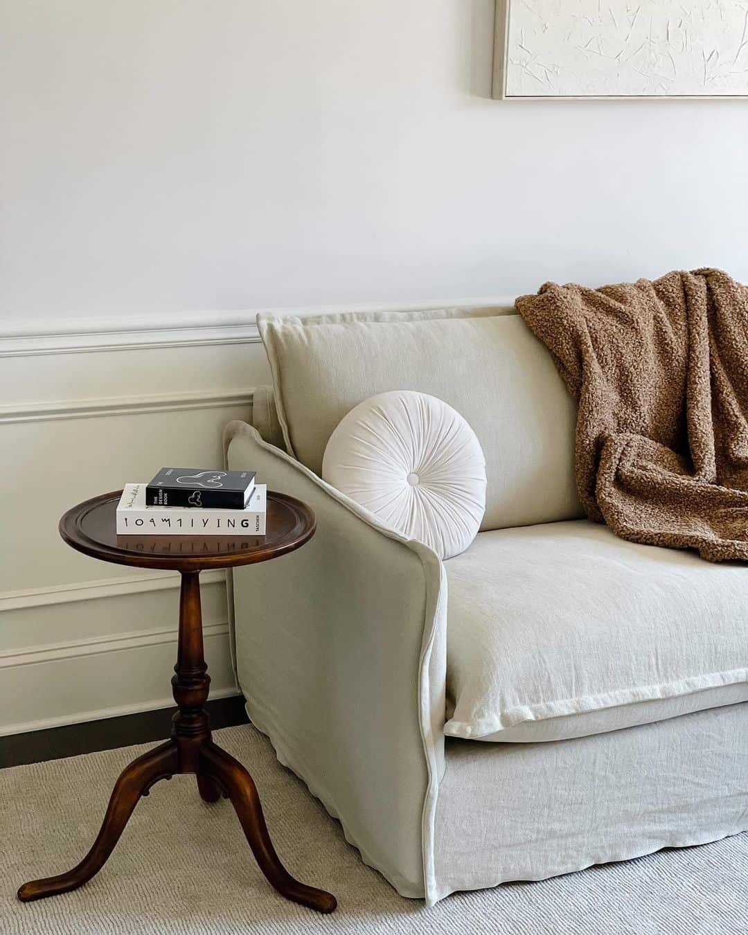 Wooden Pedestal Table and White Wainscoting